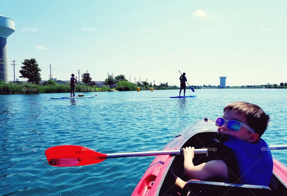 Group of people kayaking and stand up paddle boarding