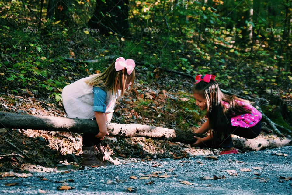 Two girls playing in forest