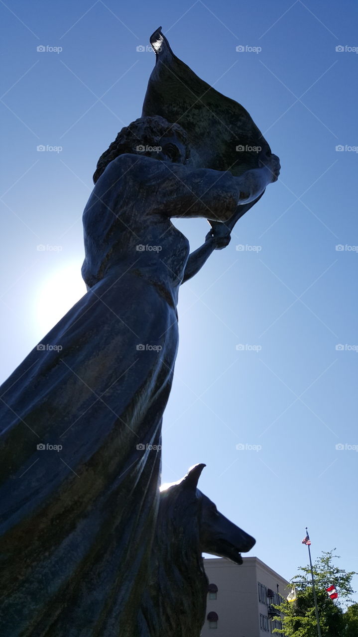A striking statue on the shore of Savannah. A woman waving the sailors in.