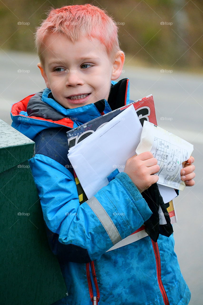 Boy getting letters from the mailbox