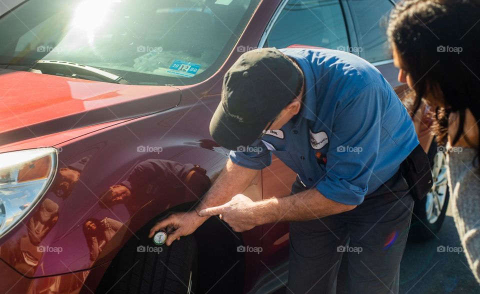 Mechanic checks tire pressure 