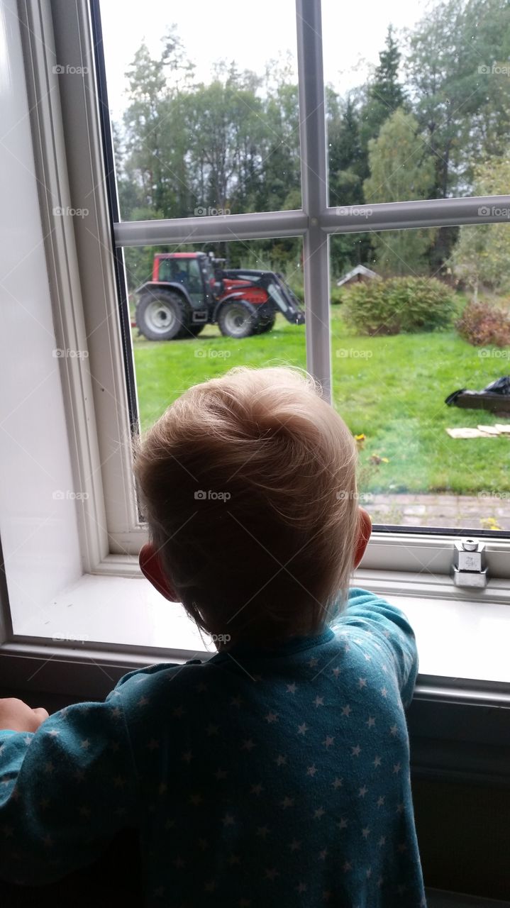 child watching a tractor