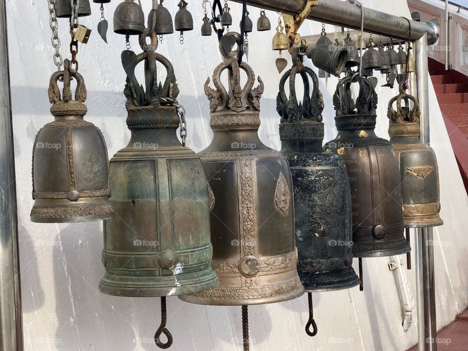 Various assorted type and models of metals bells at the entrance of a temple in Bangkok 