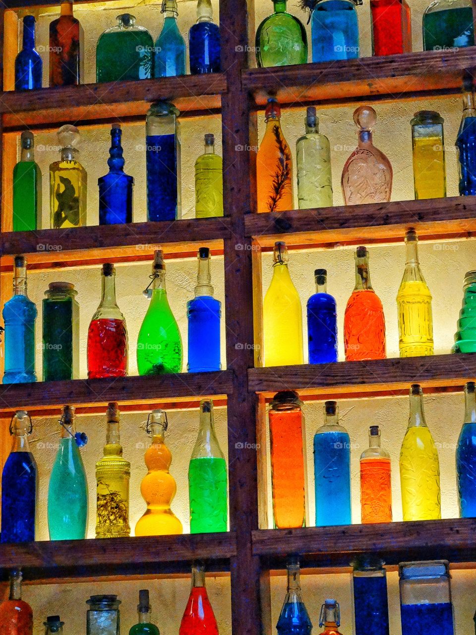 Colorful Bottles Of Liquid On A Shelf