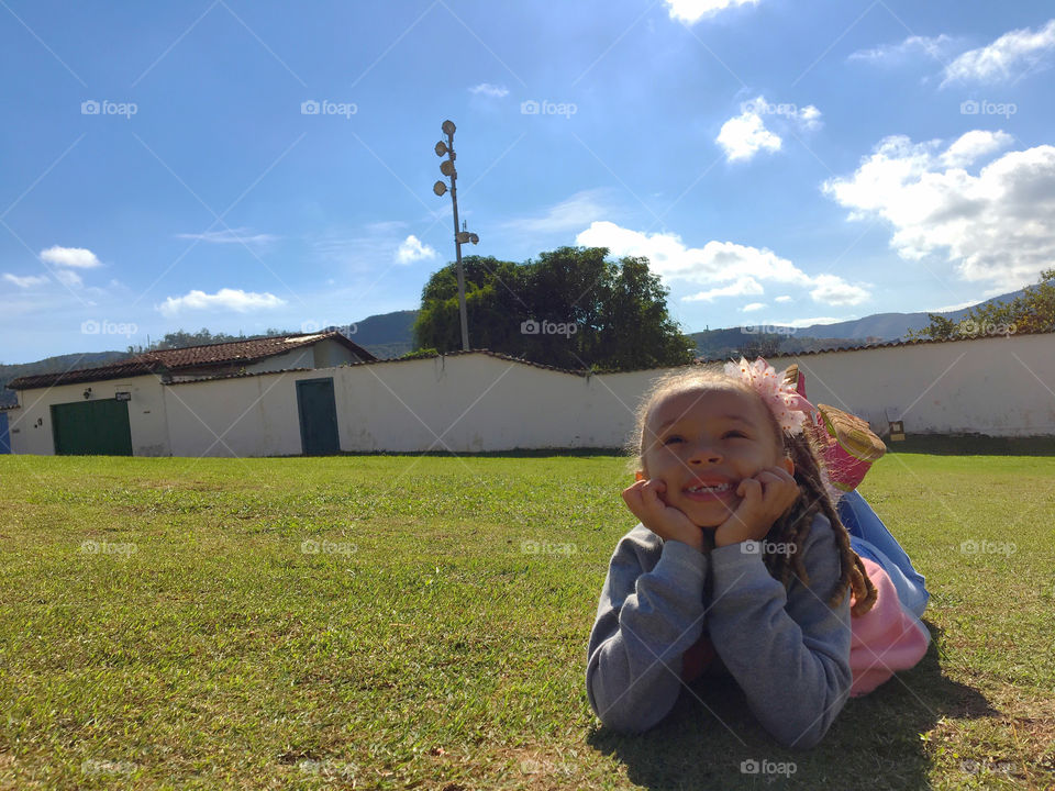 Smiling girl lying on grass