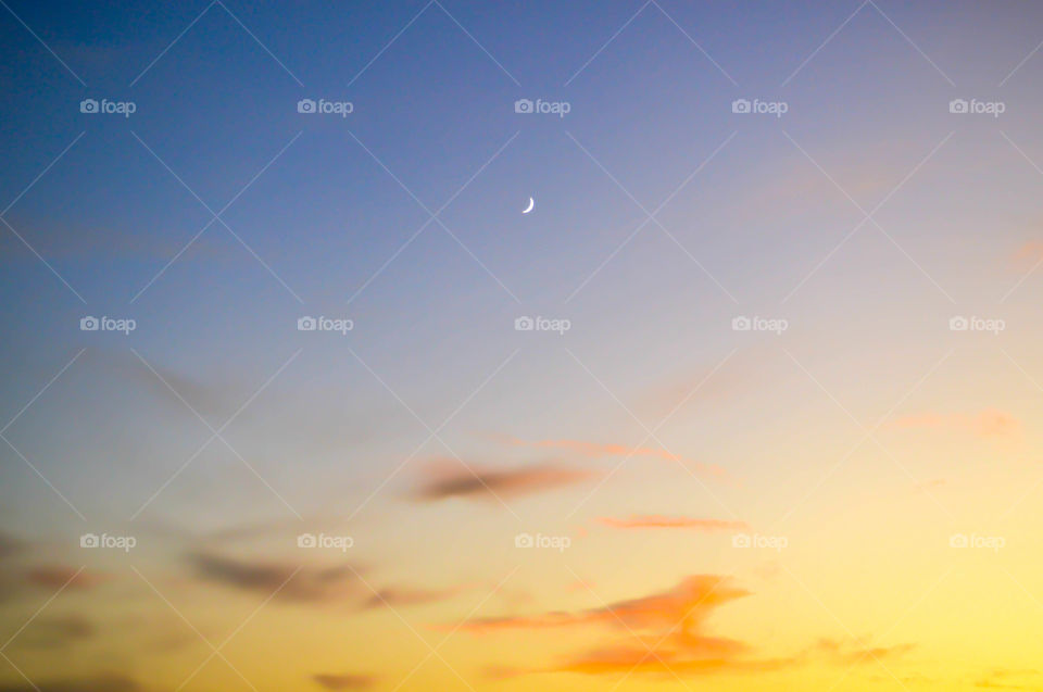 Small crescent moon in the sky during sunset