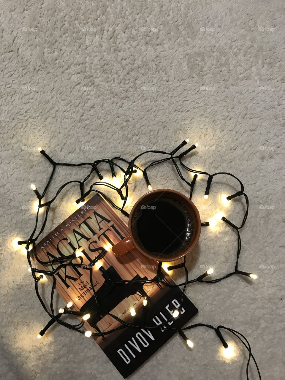 These are autumn vibes with a book and a warm cup of coffee on the cozy blanket.