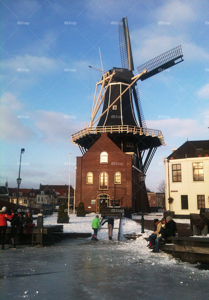 Windmill at the frozen river. Winter in the Netherlands. Windmill
at the frozen gracht in Haarlem. 