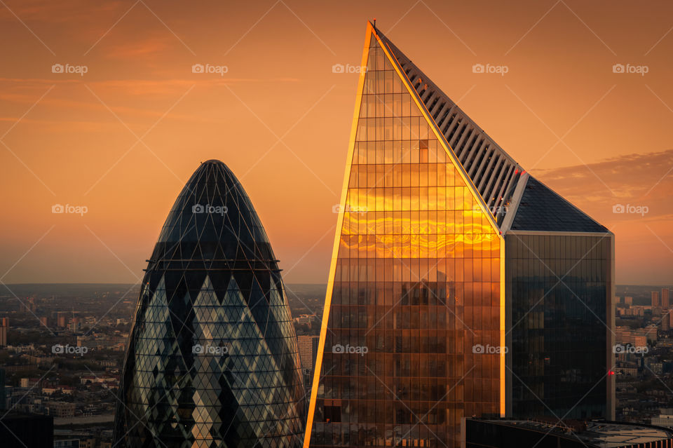 Sunset reflection in the glass surface of landmark skyscraper in city centre of London. UK.