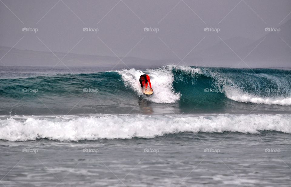 surfing on famara beach on lanzarote canary island in Spain