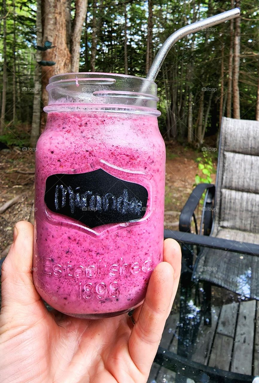 Sipping homemade smoothies from a Mason jar and reusable metal straw one summers eve.