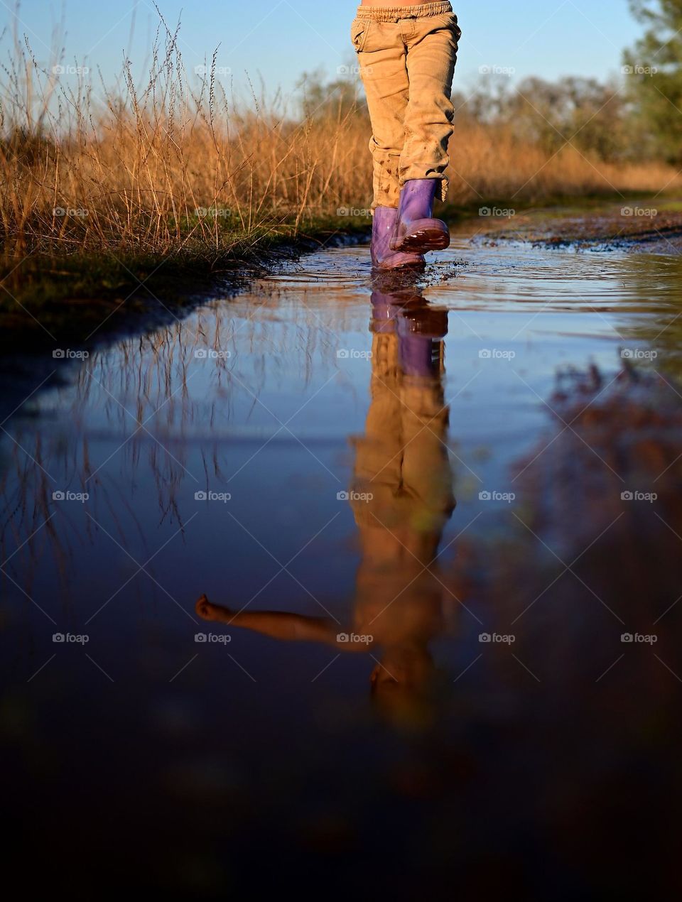 The puddle in the countryside during autumn season after the rain is so fun to play