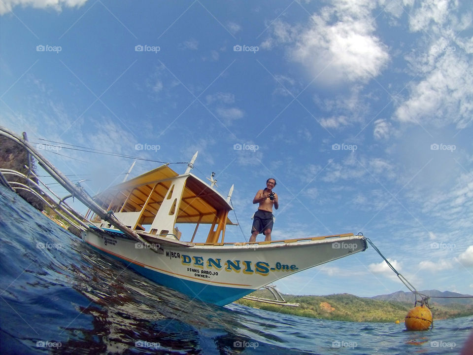 Boat and a man holding camera