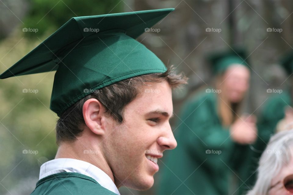 A happy graduate man in mortarboard