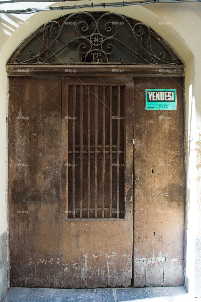 Old door in the city of Cefalu on Sicily.