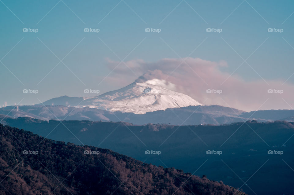 Scenic view of snowy mountain in foggy weather