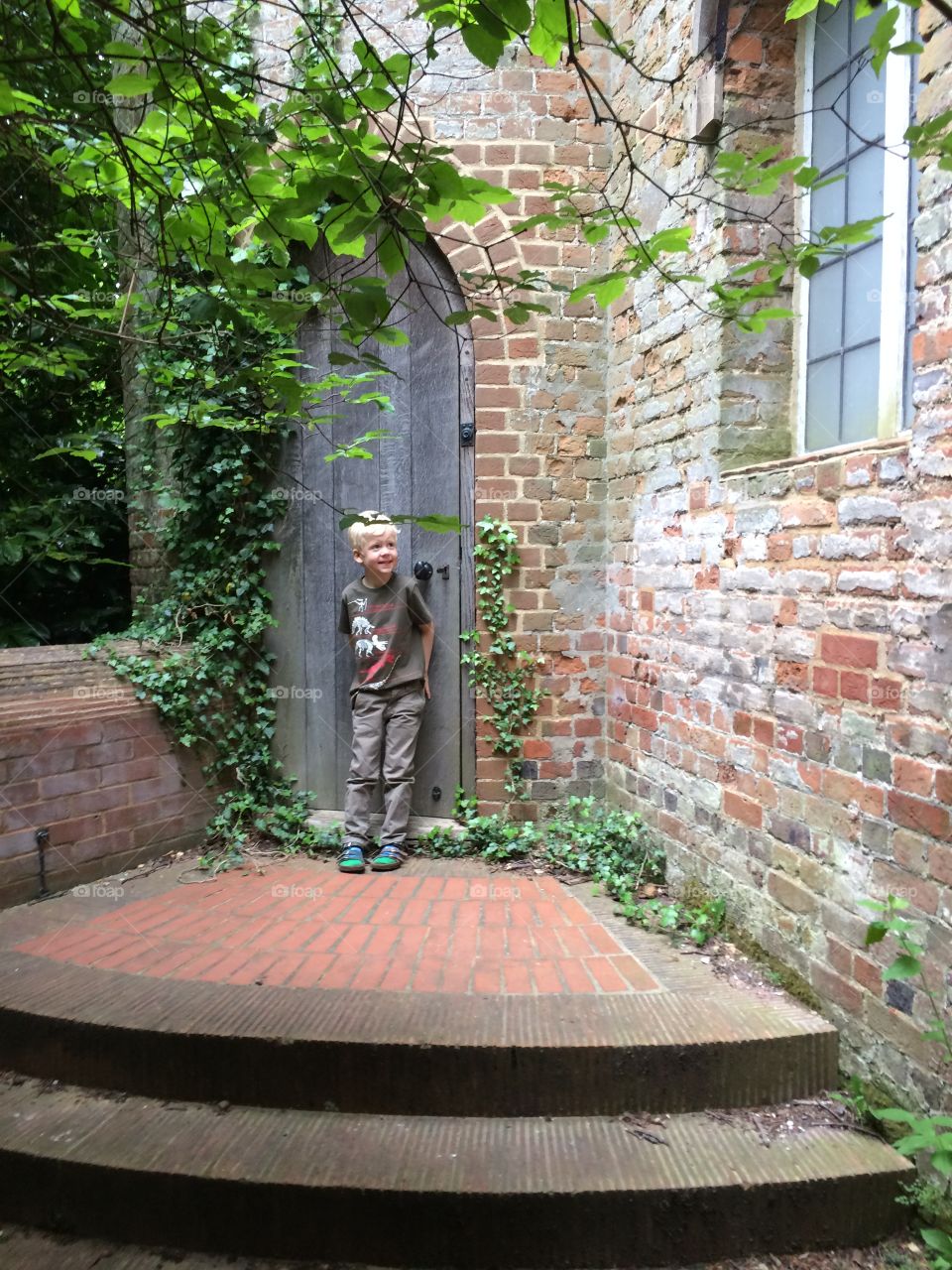 Hidden door to the Gothic Tower, Painshill, Surrey. Steps leading to Gothic Tower, Painshill, Surrey, England