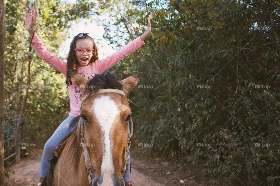 Child riding a horse