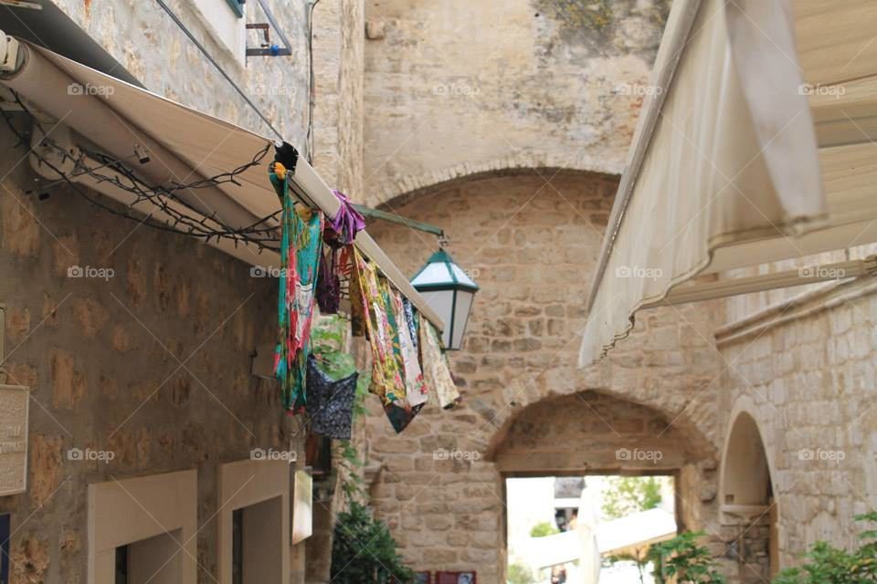 A scenic town view of some washing on the line in a traditional and beautiful alleyway in Hvar
