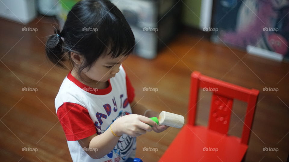 Asian girl playing with educational toy
