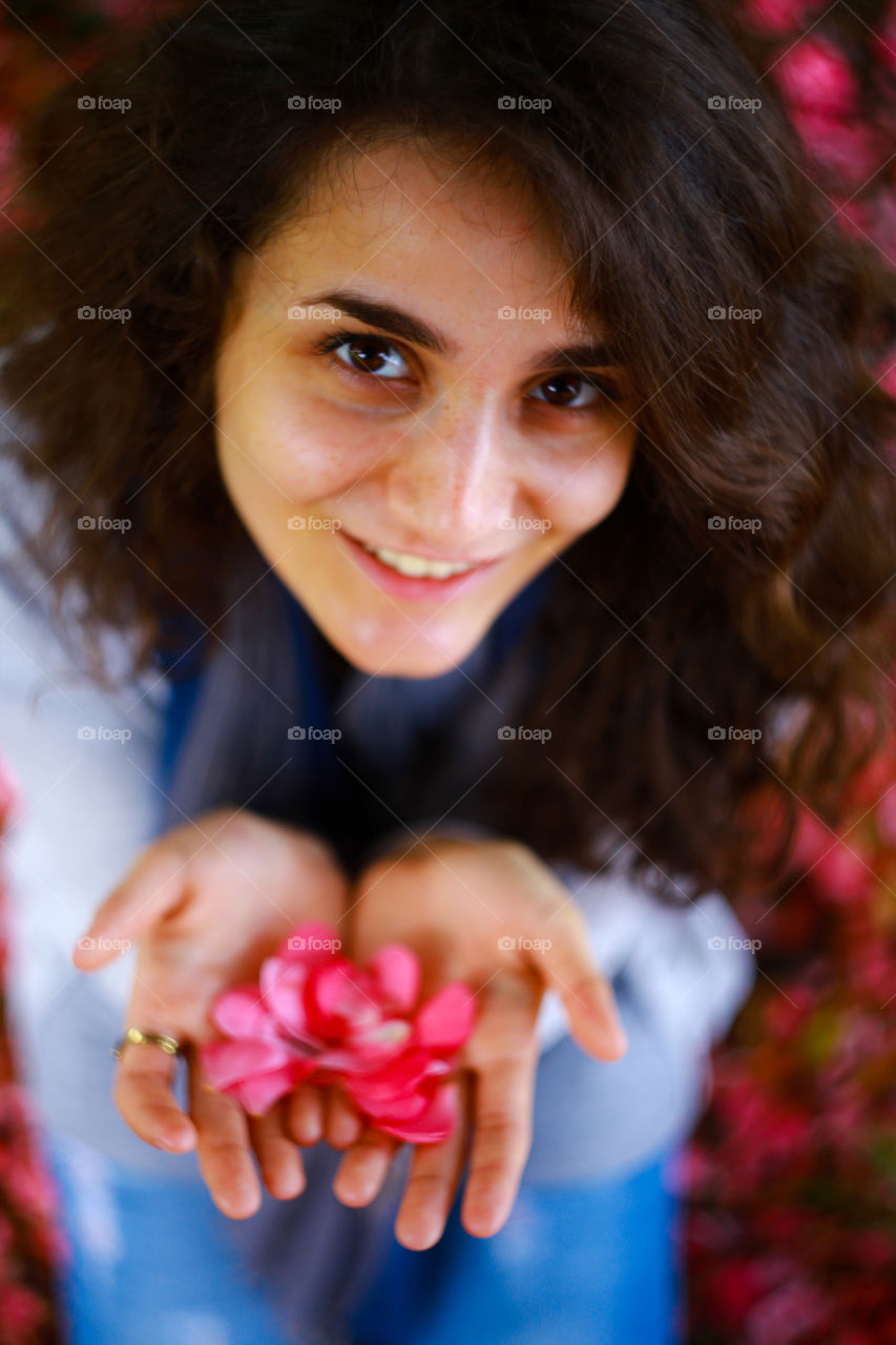 Portrait of a teenage girl with pink flower