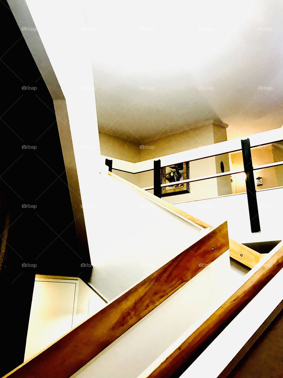 Architectural photo of a white and brown stairway with a turn in it makes for a fun photo! 