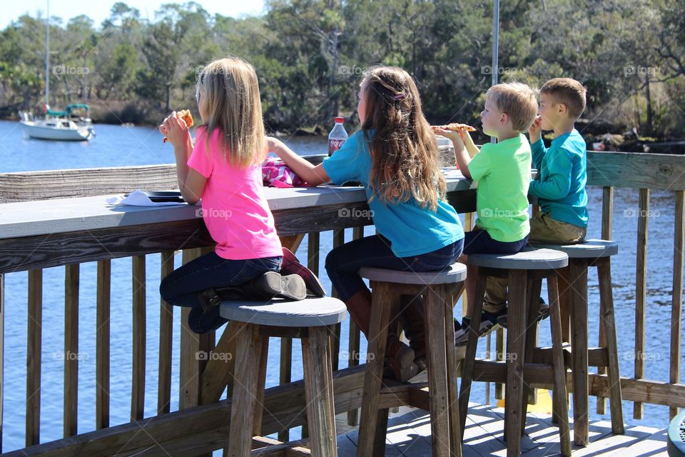 Sibling snacking on the dock