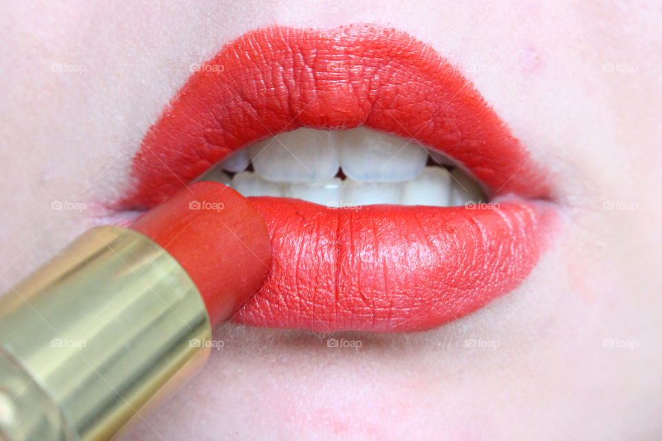 Women applying lipstick