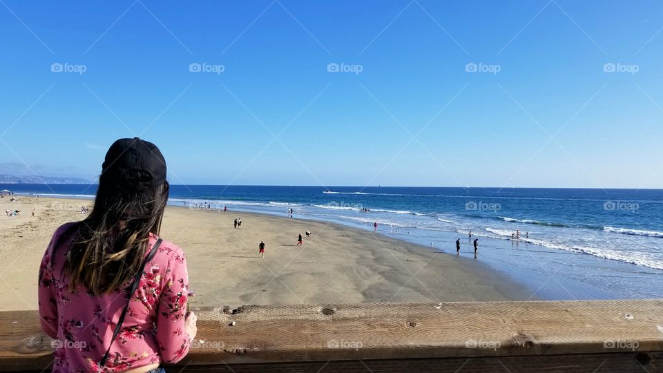 fashionable woman looking at the view of the ocean