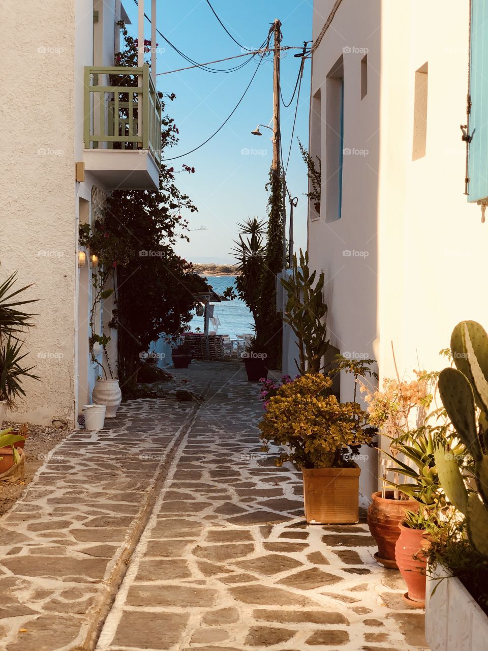 Hidden island alleyway at sunrise Greece