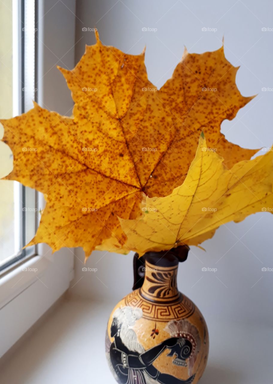 Autumn bouquet of leaves in a vase