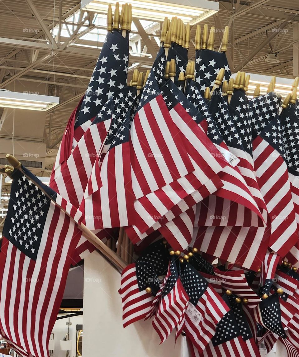 store display of many small American flags to wave for Independence Day on July 4th