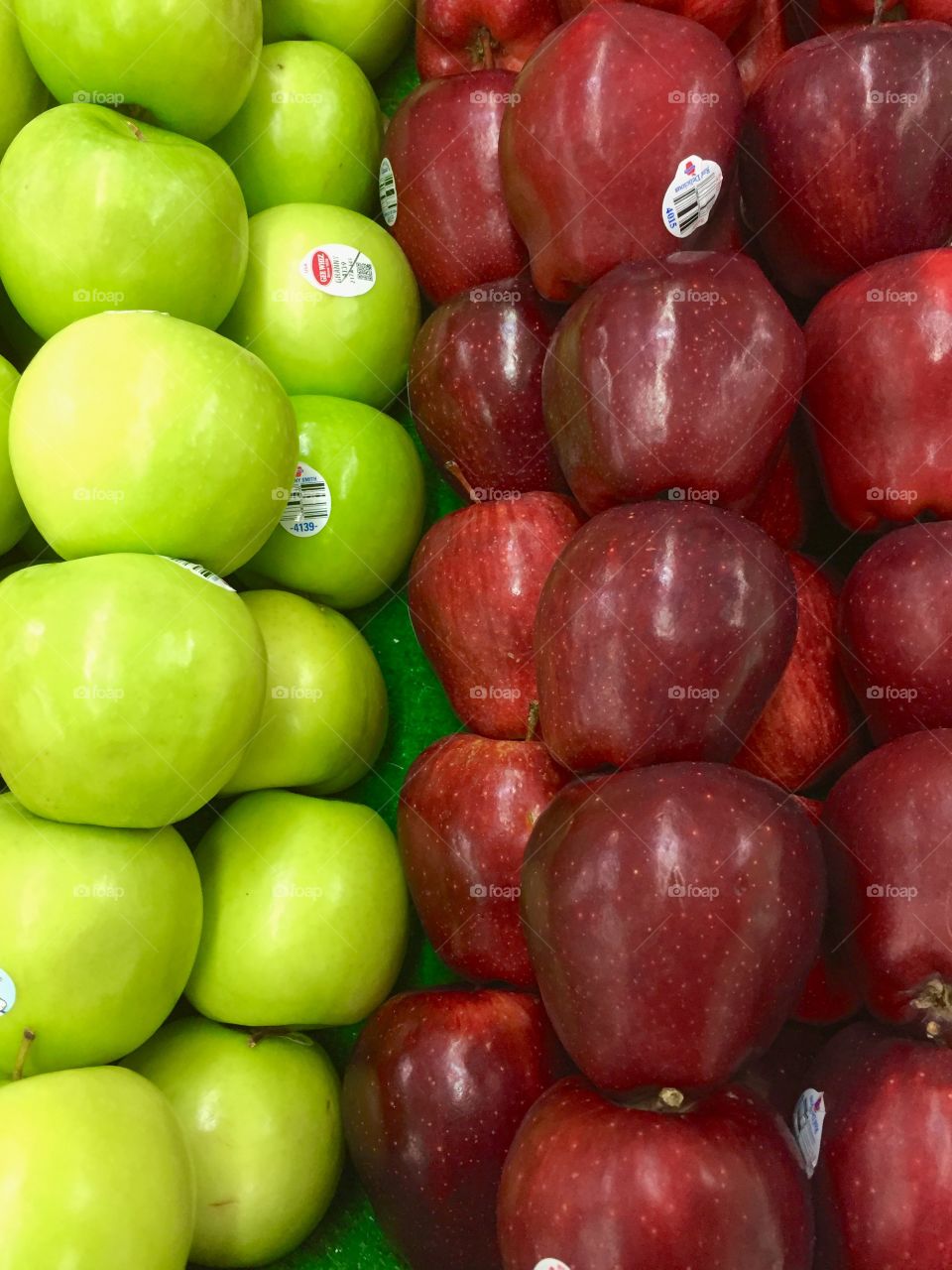 Green and red apples in the market