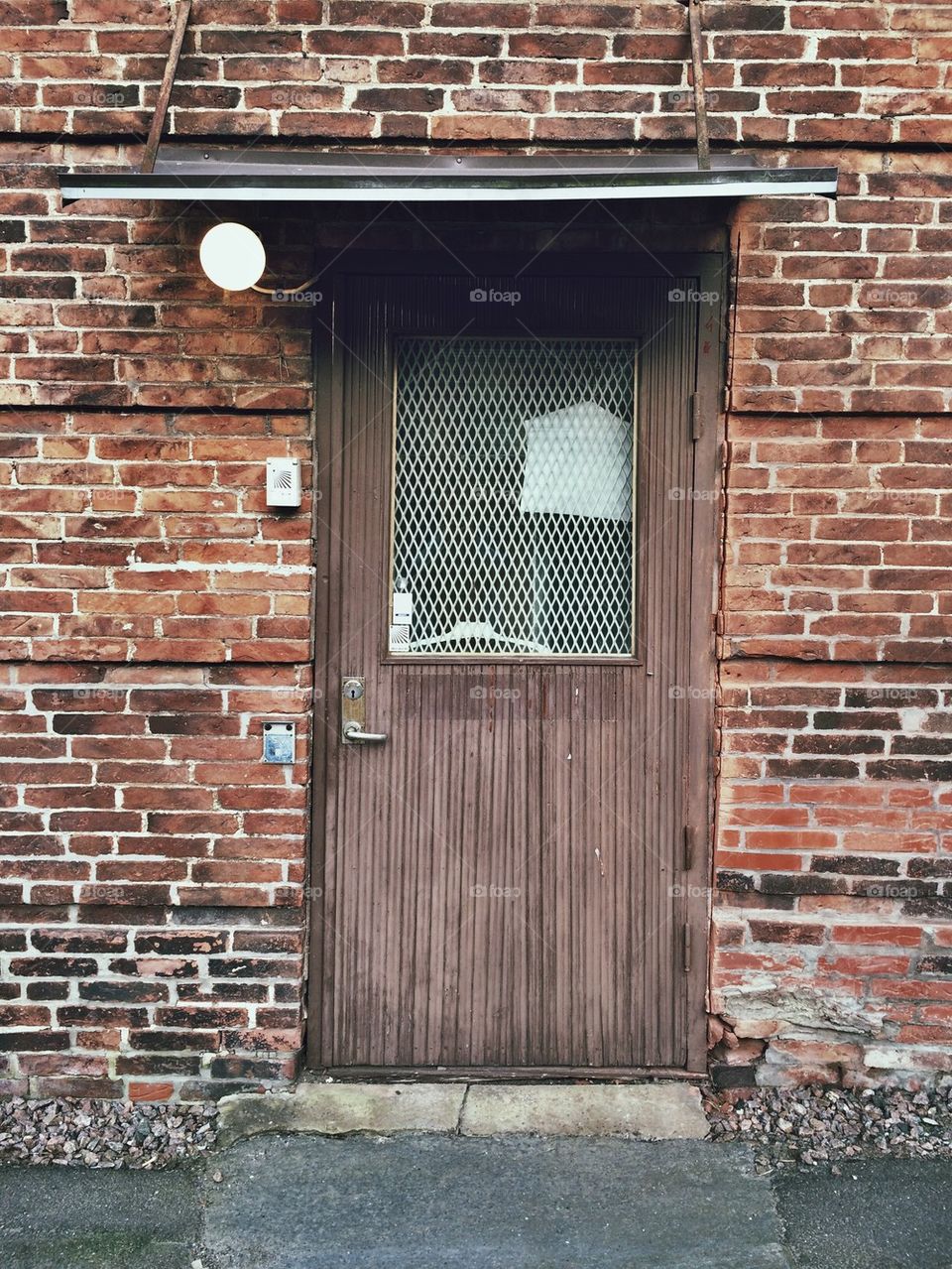 Wooden door on red brick wall