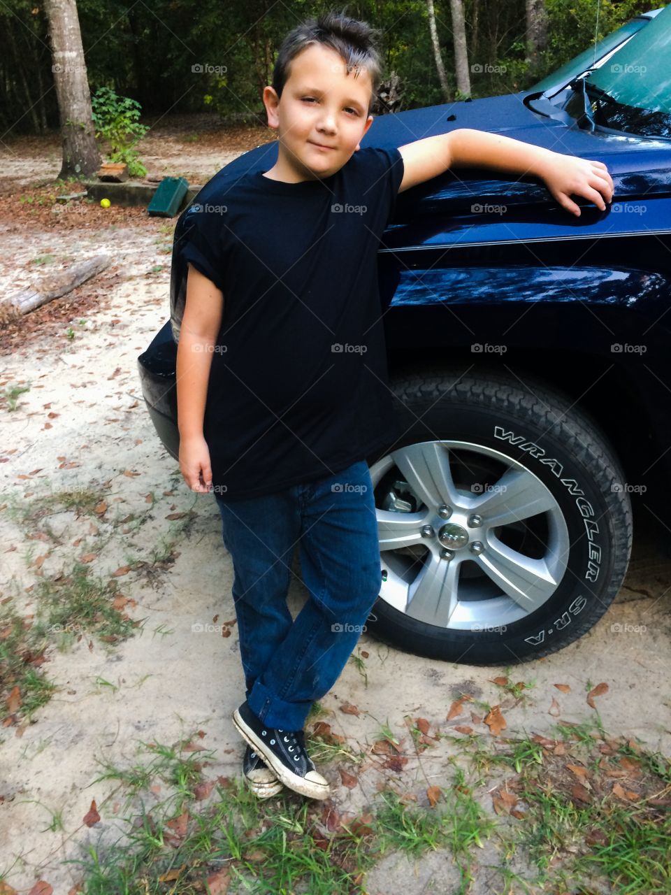 Small child standing near car