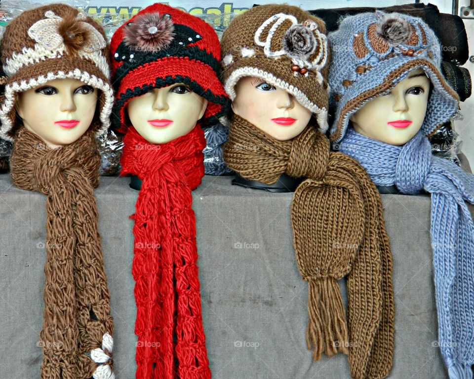 Four dressed mannequins - Designed with features of the human head and are used to display crochet hats and scarfs