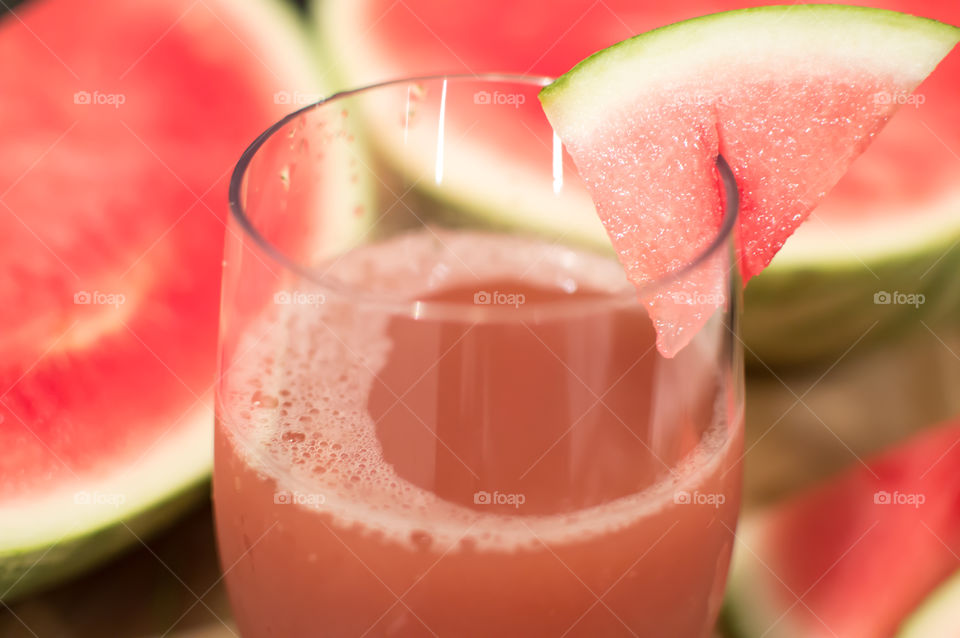 Closeup of fresh watermelon homemade juice garnished with watermelon slice for refreshing backyard party or entertaining healthy drinks  fun summer background photography 