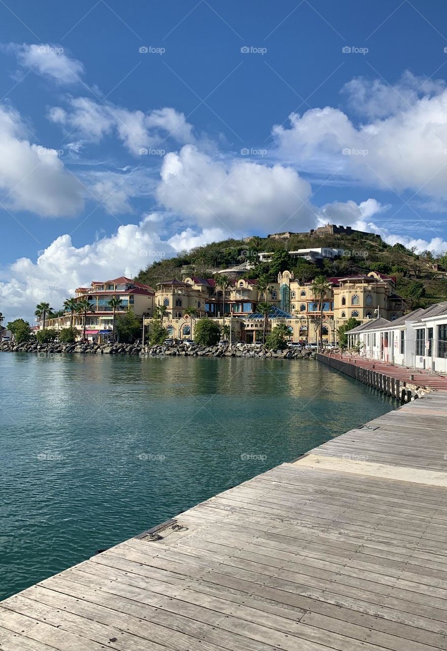 The Caribbean/Saint Martin. Beautiful blue sky with clouds in the background with a beautiful building.