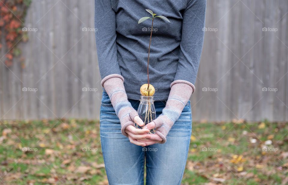 Woman holding a plant outdoors 