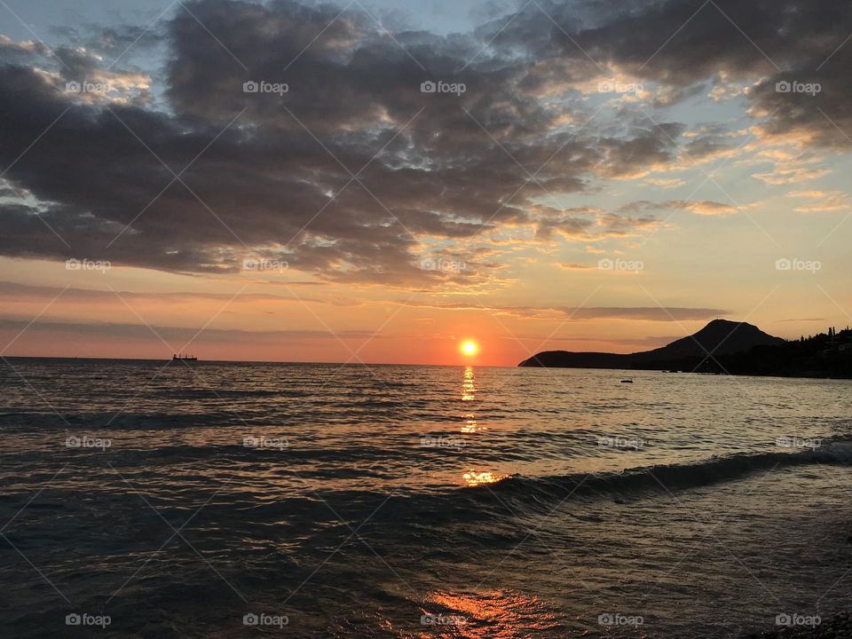 How magical it is when you are sitting peacefully on the beach in Montenegro, the city of Bar, and enjoying a peaceful time listening to the sound of waves and watching the sun setting into the sea.