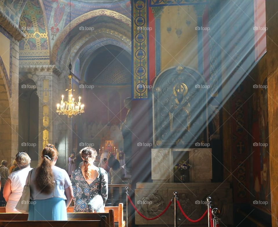 Light pours into the church and onto worshippers during a service at the Armenian Cathedral in Lviv, Ukraine