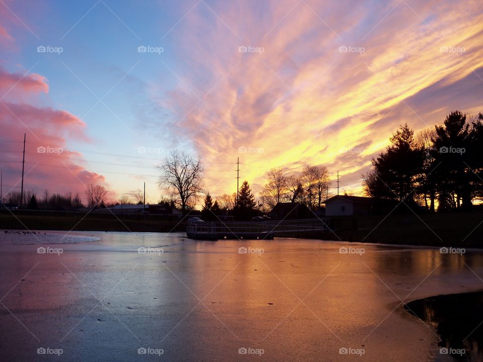 beautiful sunset over an iced pond