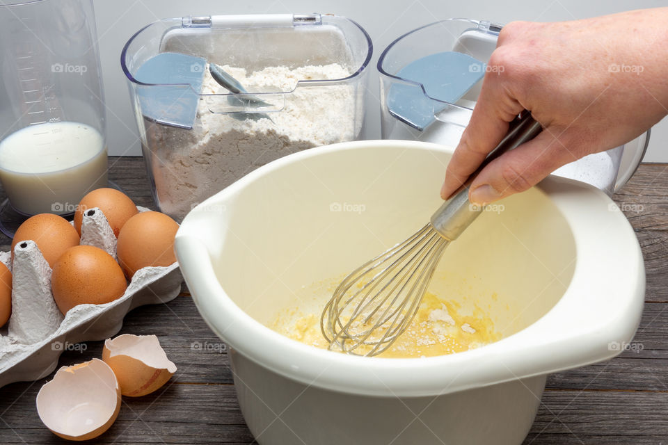 person stirs dough