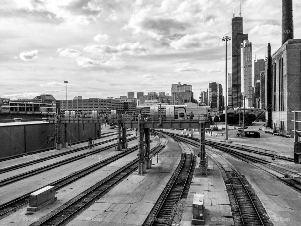 Black and white photo of a Chicago Metra train station and buildings in the background
