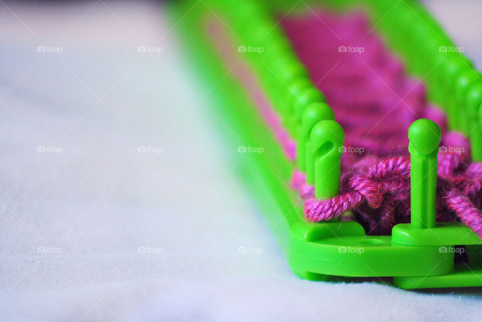 Macro shot, loom kit, yarn, pegs, knitting, diy, do it yourself, front focus, subject on the side