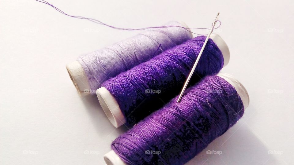 Thread and needle for sewing with shades of purple
