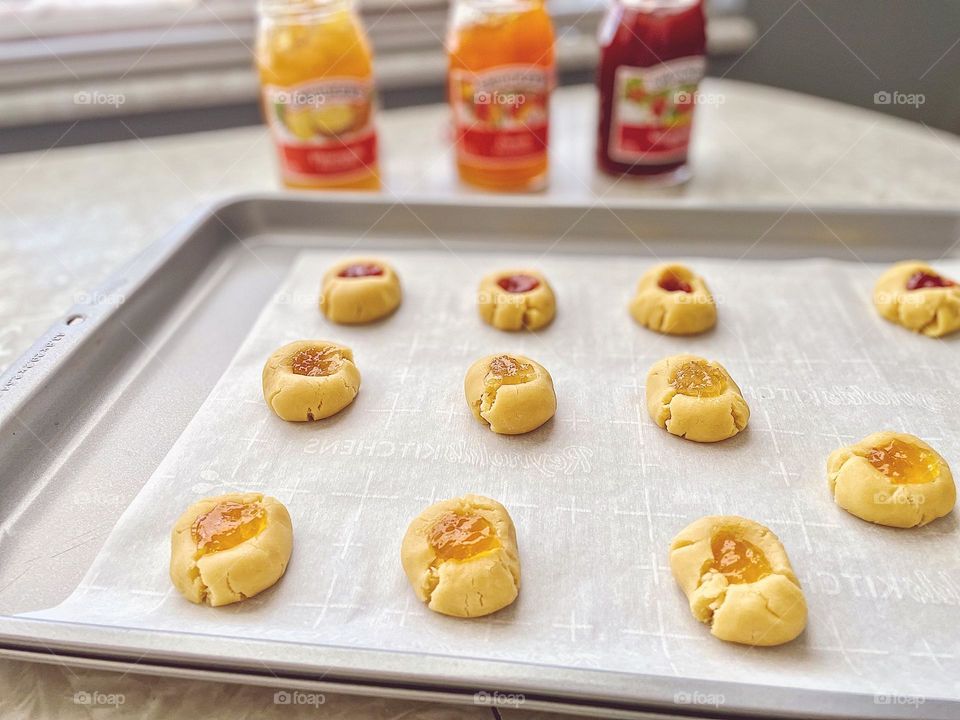 Baking cookies on Christmas, making cookies with family, thumbprint cookies about to go in the oven, cookies filled with jelly, grandma’s thumbprint cookie recipe, making cookies for the holidays, baking in the kitchen, cookies in the kitchen