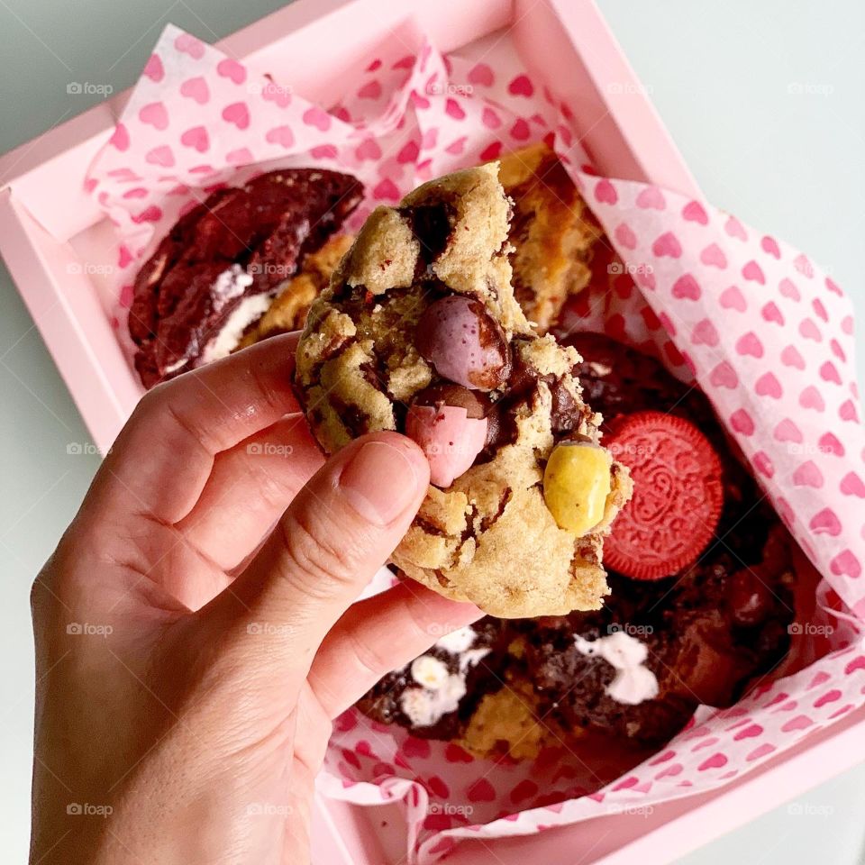Freshly baked Gooey Easter cookies in chocolate in big chunk with hot tea for afternoon snack 