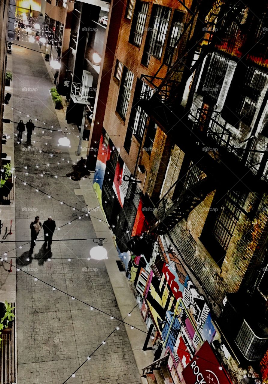 Looking down on  Detroit alley lite with decorative string lights. 