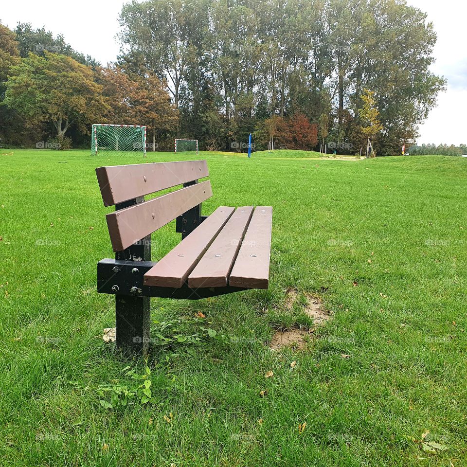 Bench to sit outside on the recreation field.